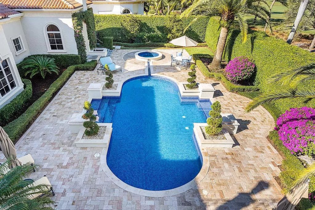 The Boca Raton Home is a luxurious five-bedroom estate complemented by the refreshed decor, seamlessly blending clean lines and traditional elegance now available for sale. This home located at 1869 Sabal Palm Dr, Boca Raton, Florida