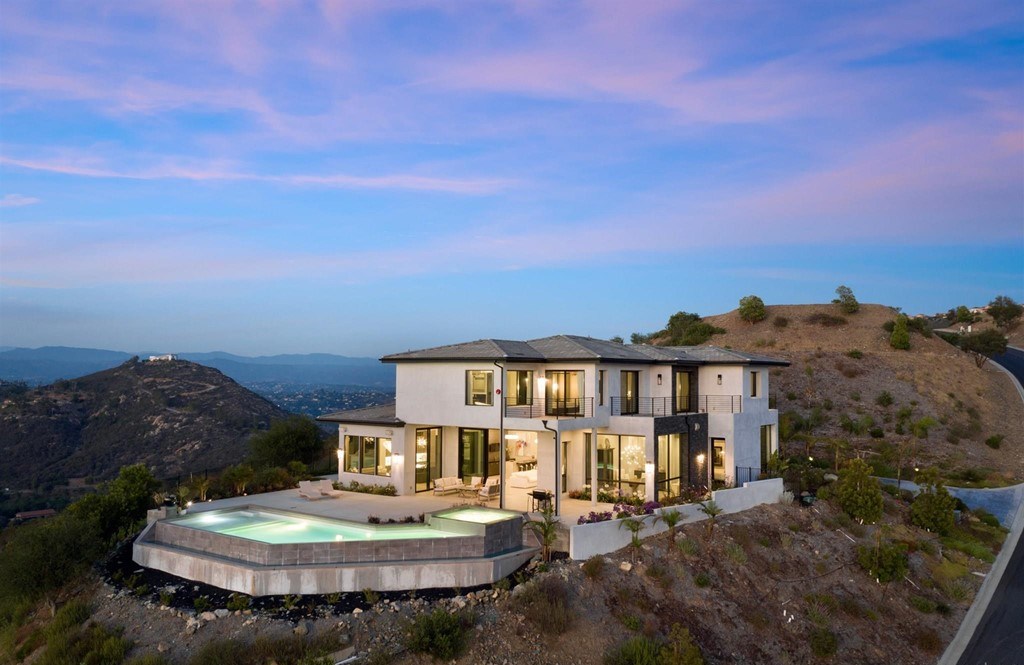 The Rancho Santa Fe Home is a private modern estate with breathtaking views of the ocean, canyons, and mountains in the community of Cielo now available for sale. This home located at 8370 Via Rancho Cielo, Rancho Santa Fe, California