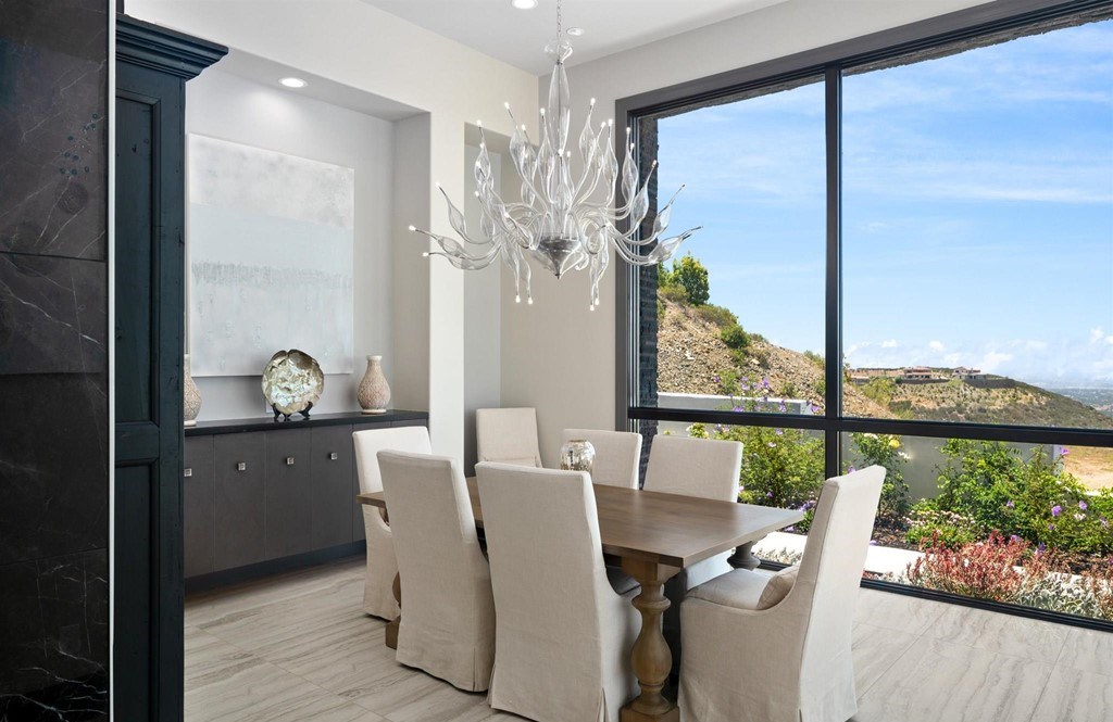 The Rancho Santa Fe Home is a private modern estate with breathtaking views of the ocean, canyons, and mountains in the community of Cielo now available for sale. This home located at 8370 Via Rancho Cielo, Rancho Santa Fe, California