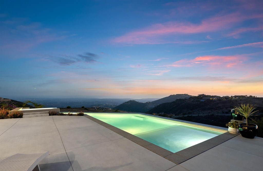 The Rancho Santa Fe Home is a private modern estate with breathtaking views of the ocean, canyons, and mountains in the community of Cielo now available for sale. This home located at 8370 Via Rancho Cielo, Rancho Santa Fe, California