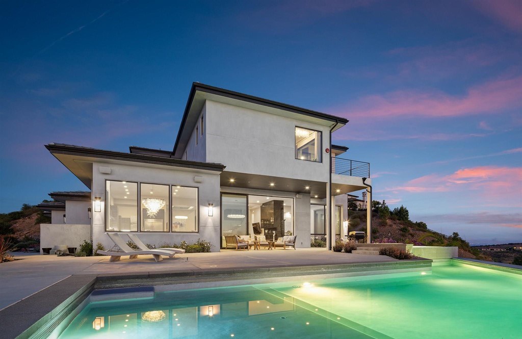 The Rancho Santa Fe Home is a private modern estate with breathtaking views of the ocean, canyons, and mountains in the community of Cielo now available for sale. This home located at 8370 Via Rancho Cielo, Rancho Santa Fe, California