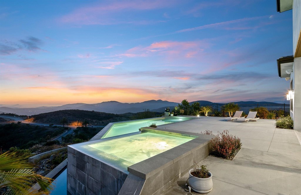 The Rancho Santa Fe Home is a private modern estate with breathtaking views of the ocean, canyons, and mountains in the community of Cielo now available for sale. This home located at 8370 Via Rancho Cielo, Rancho Santa Fe, California