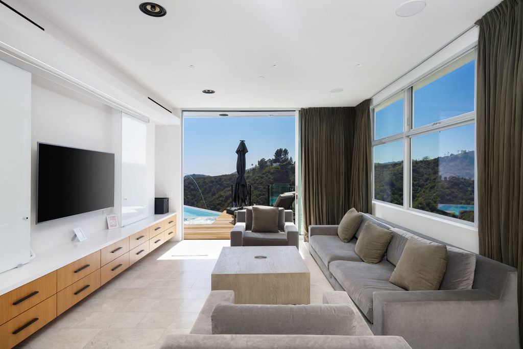 The Home in Los Angeles is a distinguished architectural masterpiece sited in prime Bel Air boasts panoramic city, ocean, and mountain views now available for sale. This home located at 1979 Stradella Rd, Los Angeles, California