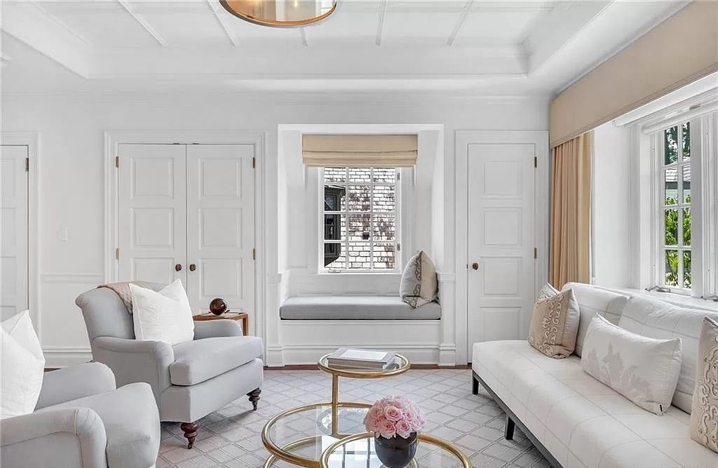 Decorate the window seats in the living room to make a comfortable place to read, drink coffee, and take in some natural light. To warm up the area, start with a long seat cushion. Add some accent pillows so you may unwind by sitting back. For storage of your reading materials, choose a pretty tray. Lacking a roomy window seat area? Make one of your own with a bench!
