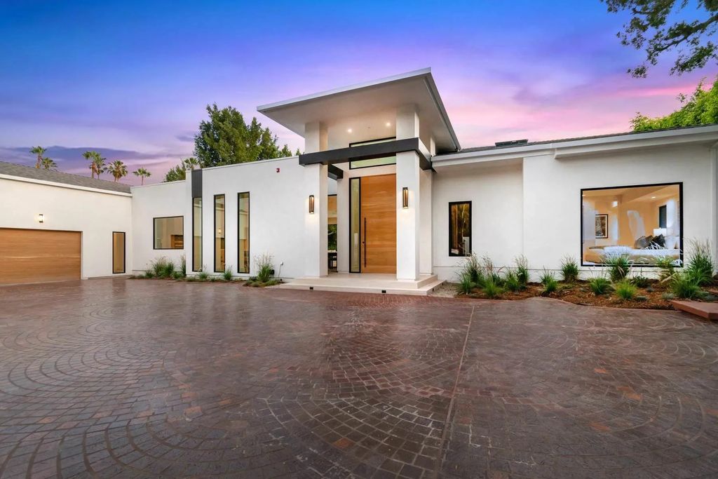 The Home in Beverly Hills is a captivating reimagined single-story sanctuary, situated behind private gates now available for sale. This home located at 410 Doheny Rd, Beverly Hills, California