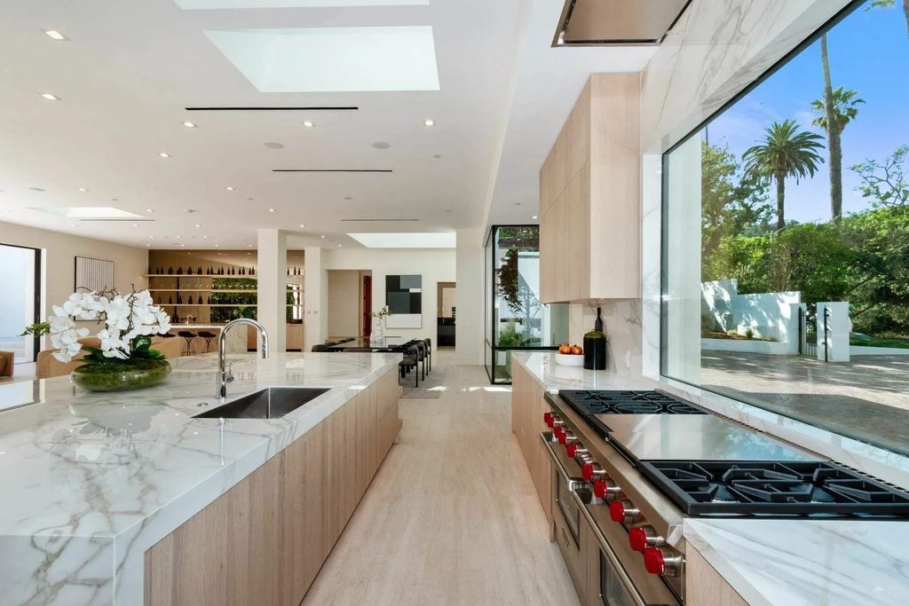 The Home in Beverly Hills is a captivating reimagined single-story sanctuary, situated behind private gates now available for sale. This home located at 410 Doheny Rd, Beverly Hills, California