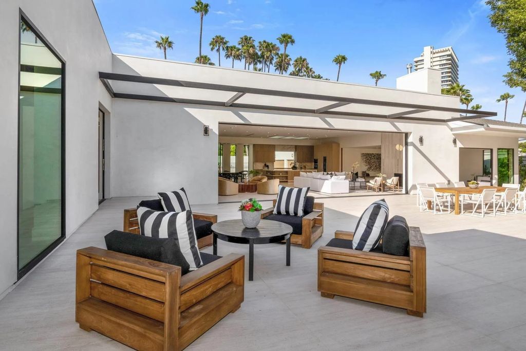 The Home in Beverly Hills is a captivating reimagined single-story sanctuary, situated behind private gates now available for sale. This home located at 410 Doheny Rd, Beverly Hills, California