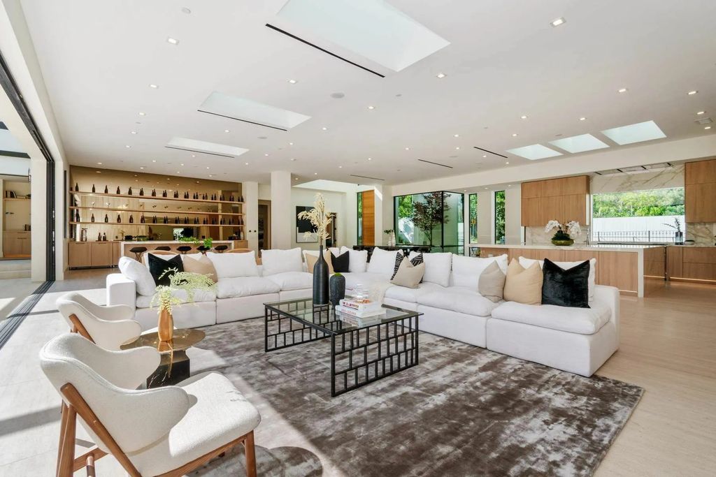 The Home in Beverly Hills is a captivating reimagined single-story sanctuary, situated behind private gates now available for sale. This home located at 410 Doheny Rd, Beverly Hills, California