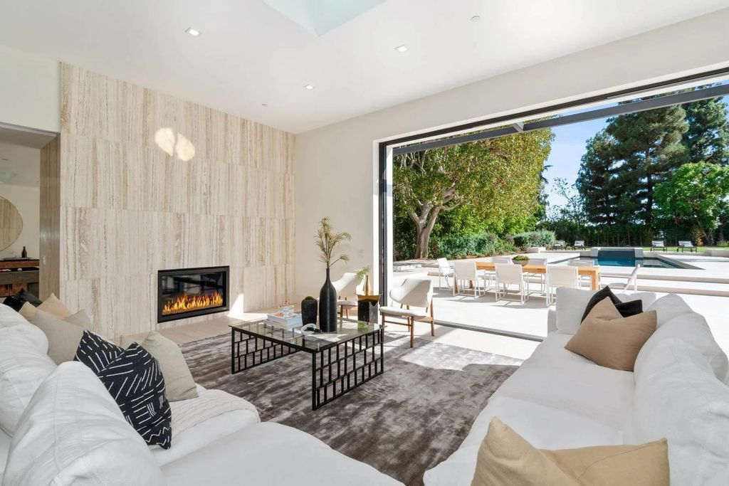 The Home in Beverly Hills is a captivating reimagined single-story sanctuary, situated behind private gates now available for sale. This home located at 410 Doheny Rd, Beverly Hills, California