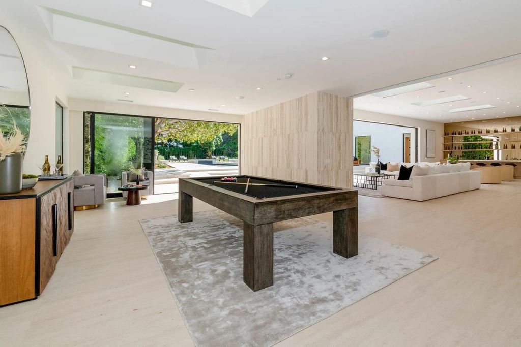 The Home in Beverly Hills is a captivating reimagined single-story sanctuary, situated behind private gates now available for sale. This home located at 410 Doheny Rd, Beverly Hills, California