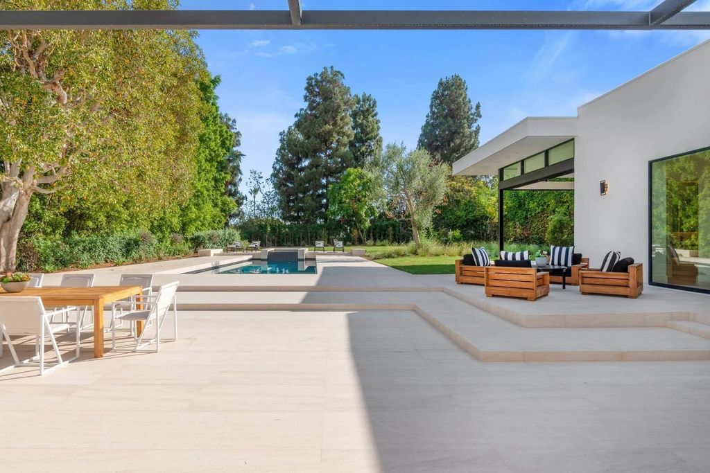 The Home in Beverly Hills is a captivating reimagined single-story sanctuary, situated behind private gates now available for sale. This home located at 410 Doheny Rd, Beverly Hills, California