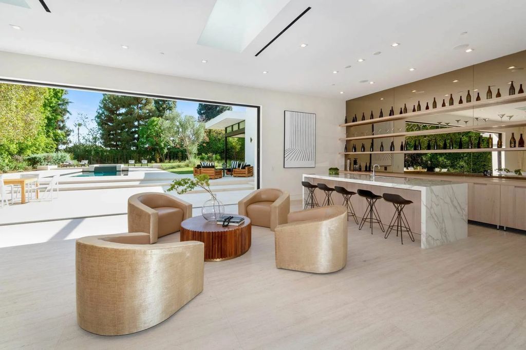 The Home in Beverly Hills is a captivating reimagined single-story sanctuary, situated behind private gates now available for sale. This home located at 410 Doheny Rd, Beverly Hills, California