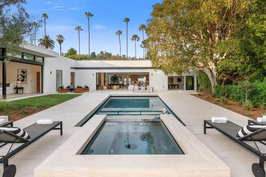 The Home in Beverly Hills is a captivating reimagined single-story sanctuary, situated behind private gates now available for sale. This home located at 410 Doheny Rd, Beverly Hills, California