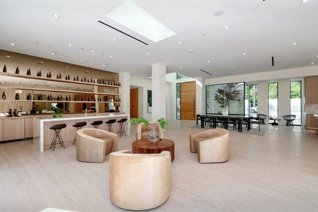 The Home in Beverly Hills is a captivating reimagined single-story sanctuary, situated behind private gates now available for sale. This home located at 410 Doheny Rd, Beverly Hills, California