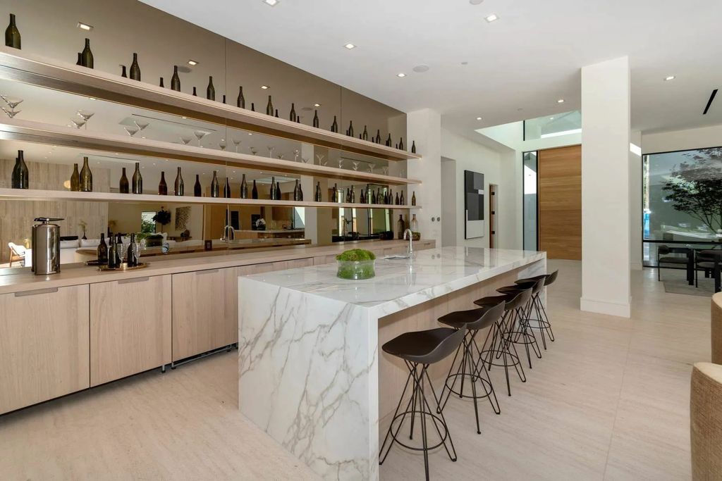 The Home in Beverly Hills is a captivating reimagined single-story sanctuary, situated behind private gates now available for sale. This home located at 410 Doheny Rd, Beverly Hills, California