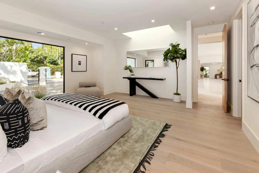 The Home in Beverly Hills is a captivating reimagined single-story sanctuary, situated behind private gates now available for sale. This home located at 410 Doheny Rd, Beverly Hills, California