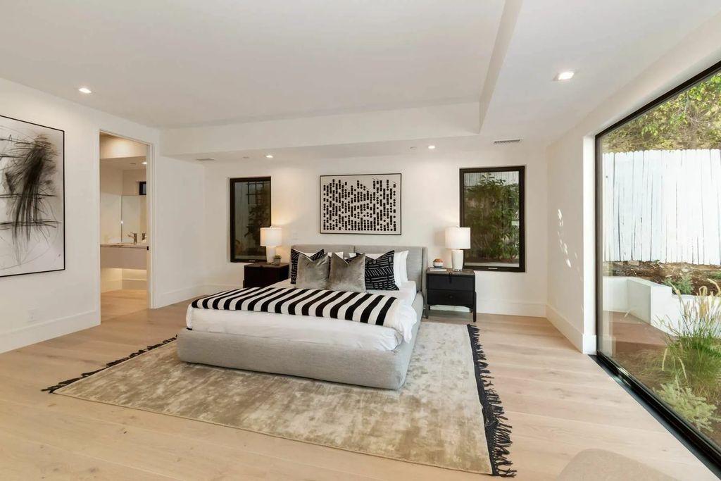 The Home in Beverly Hills is a captivating reimagined single-story sanctuary, situated behind private gates now available for sale. This home located at 410 Doheny Rd, Beverly Hills, California