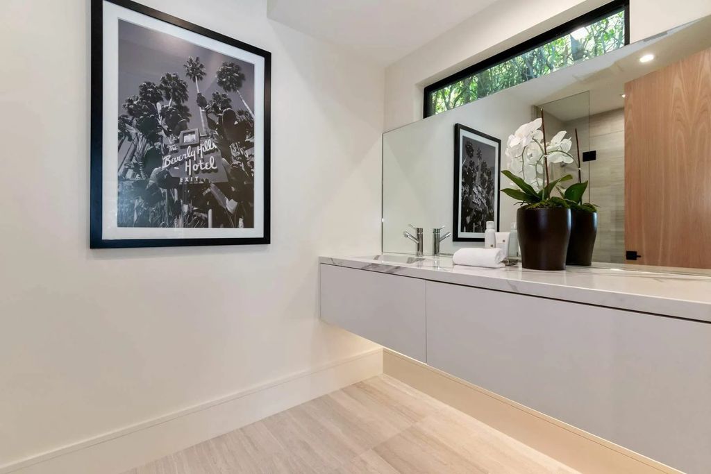 The Home in Beverly Hills is a captivating reimagined single-story sanctuary, situated behind private gates now available for sale. This home located at 410 Doheny Rd, Beverly Hills, California