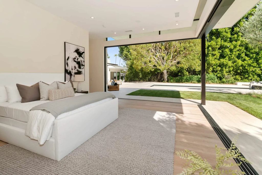The Home in Beverly Hills is a captivating reimagined single-story sanctuary, situated behind private gates now available for sale. This home located at 410 Doheny Rd, Beverly Hills, California