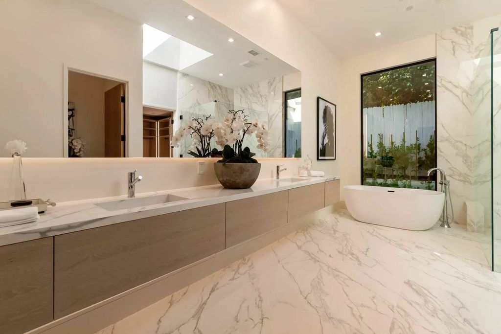 The Home in Beverly Hills is a captivating reimagined single-story sanctuary, situated behind private gates now available for sale. This home located at 410 Doheny Rd, Beverly Hills, California