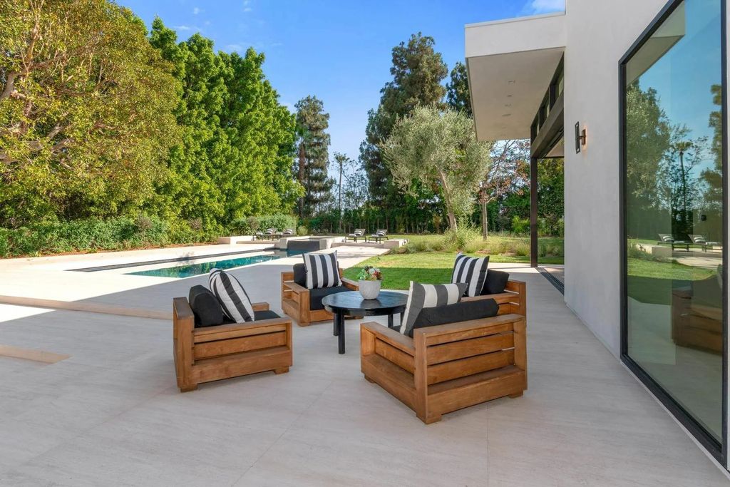 The Home in Beverly Hills is a captivating reimagined single-story sanctuary, situated behind private gates now available for sale. This home located at 410 Doheny Rd, Beverly Hills, California