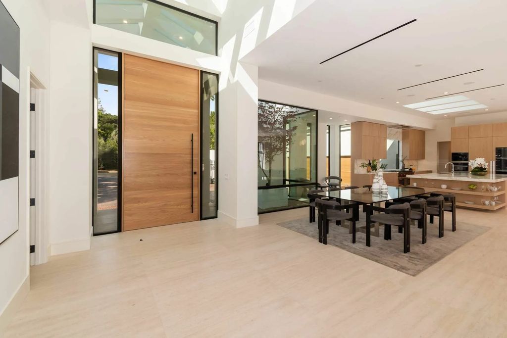The Home in Beverly Hills is a captivating reimagined single-story sanctuary, situated behind private gates now available for sale. This home located at 410 Doheny Rd, Beverly Hills, California