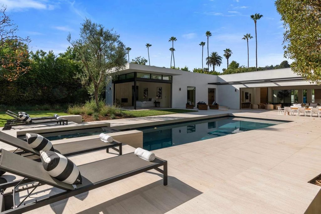 The Home in Beverly Hills is a captivating reimagined single-story sanctuary, situated behind private gates now available for sale. This home located at 410 Doheny Rd, Beverly Hills, California