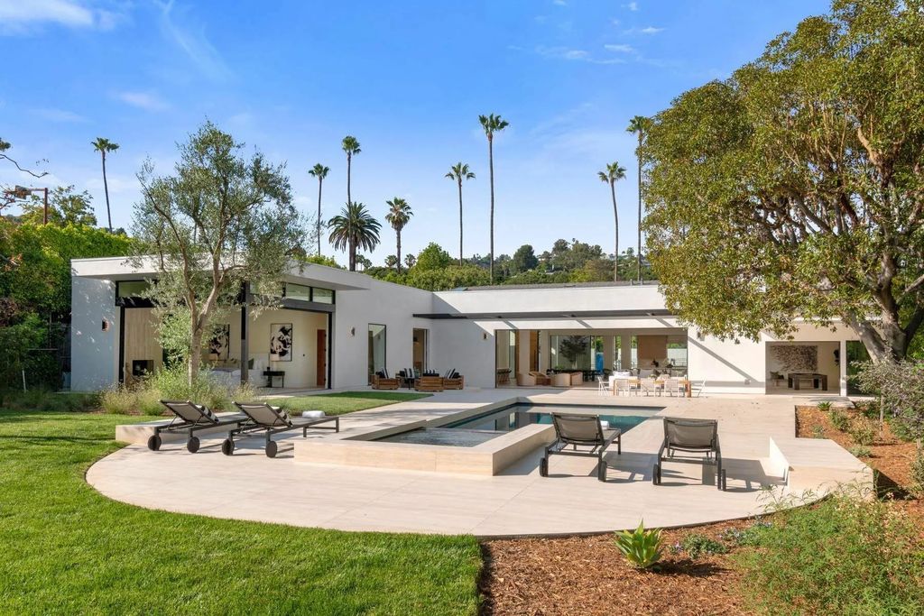 The Home in Beverly Hills is a captivating reimagined single-story sanctuary, situated behind private gates now available for sale. This home located at 410 Doheny Rd, Beverly Hills, California