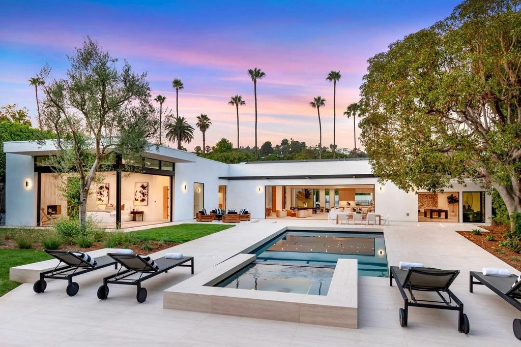 The Home in Beverly Hills is a captivating reimagined single-story sanctuary, situated behind private gates now available for sale. This home located at 410 Doheny Rd, Beverly Hills, California