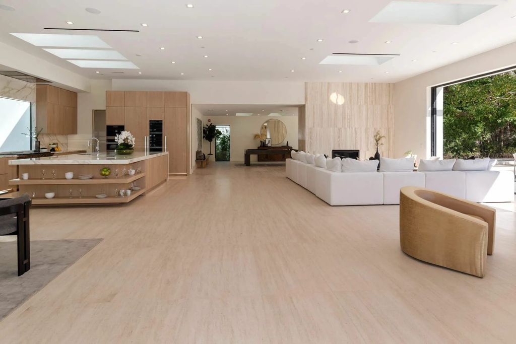 The Home in Beverly Hills is a captivating reimagined single-story sanctuary, situated behind private gates now available for sale. This home located at 410 Doheny Rd, Beverly Hills, California