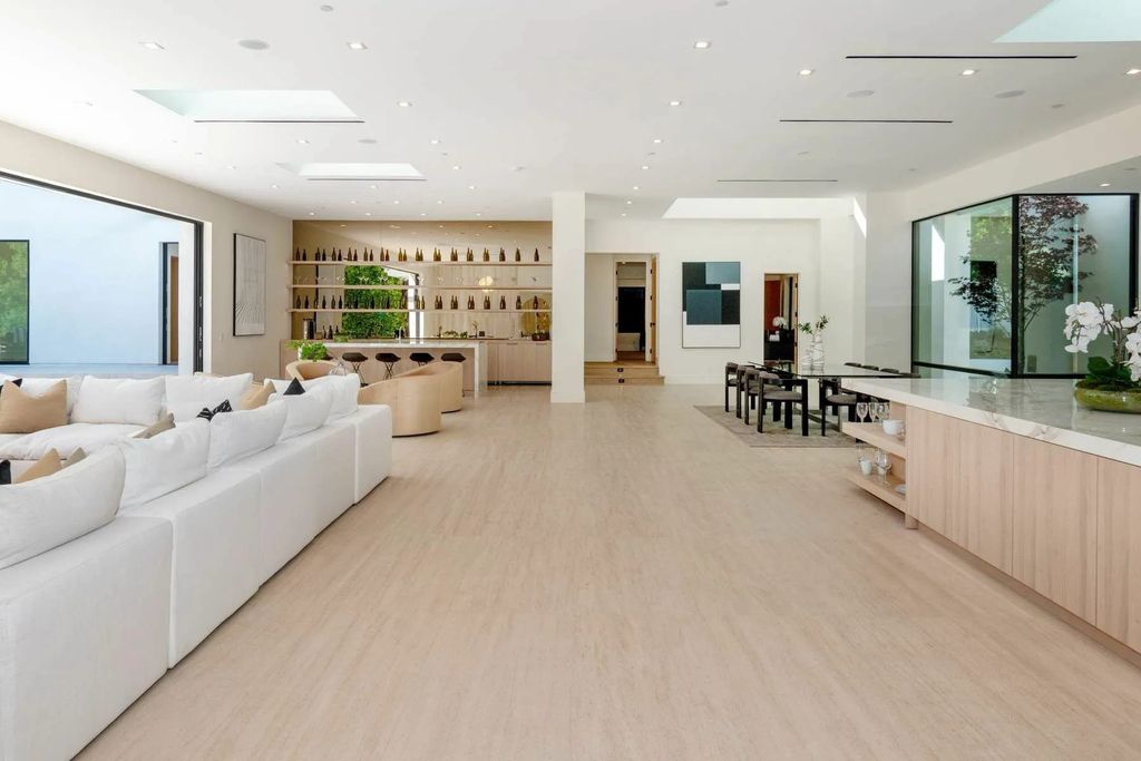 The Home in Beverly Hills is a captivating reimagined single-story sanctuary, situated behind private gates now available for sale. This home located at 410 Doheny Rd, Beverly Hills, California