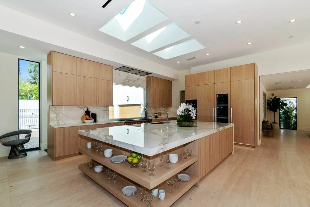 The Home in Beverly Hills is a captivating reimagined single-story sanctuary, situated behind private gates now available for sale. This home located at 410 Doheny Rd, Beverly Hills, California