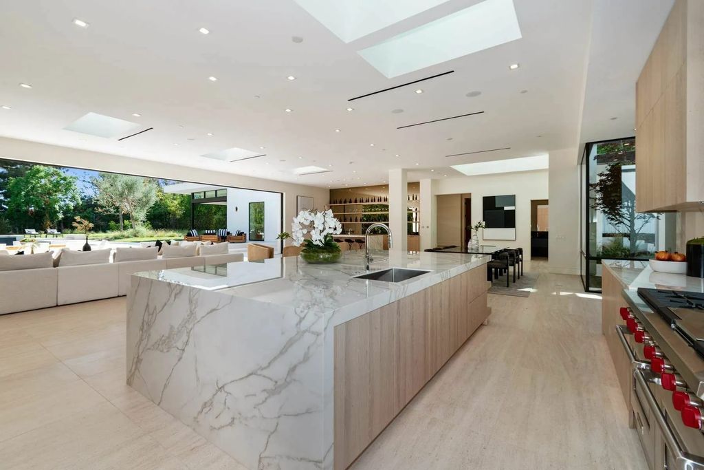 The Home in Beverly Hills is a captivating reimagined single-story sanctuary, situated behind private gates now available for sale. This home located at 410 Doheny Rd, Beverly Hills, California