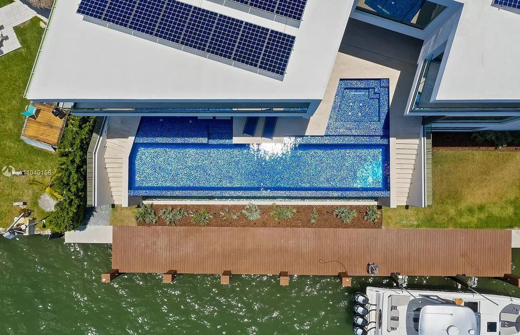 The Home in Miami is a brand new luxury modern estate with stunning bay views and over 100 feet of linear waterfront now available for sale. This home located at 1133 Belle Meade Island Dr, Miami, Florida