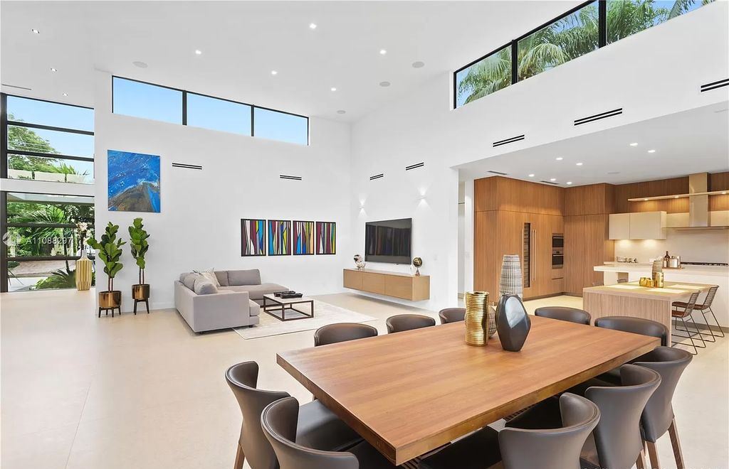 The Miami Home is a stunning brand new modern estate with enormous impact windows and doors offering an abundance of natural light now available for sale. This home located at 7362 SW 104th St, Miami, Florida