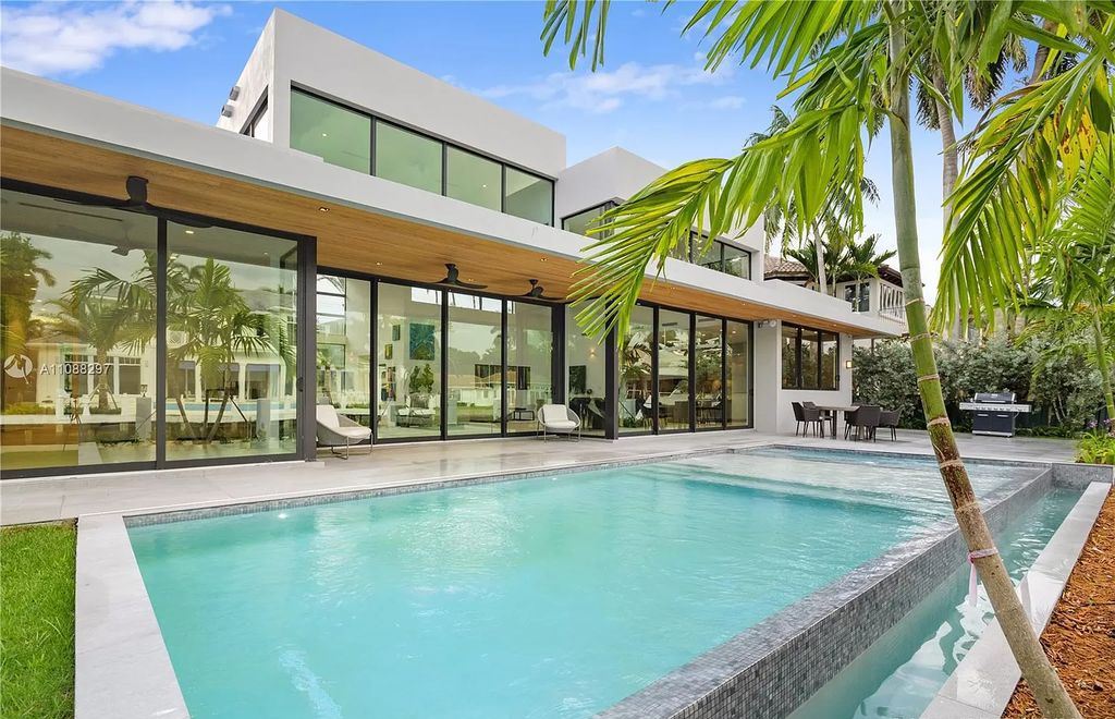The Miami Home is a stunning brand new modern estate with enormous impact windows and doors offering an abundance of natural light now available for sale. This home located at 7362 SW 104th St, Miami, Florida