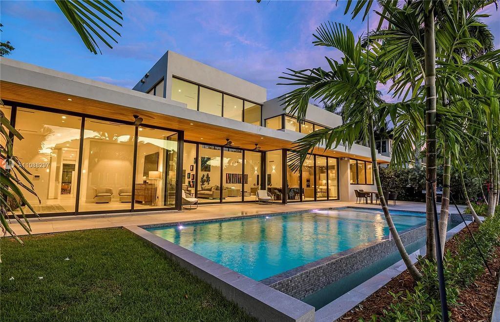 The Miami Home is a stunning brand new modern estate with enormous impact windows and doors offering an abundance of natural light now available for sale. This home located at 7362 SW 104th St, Miami, Florida