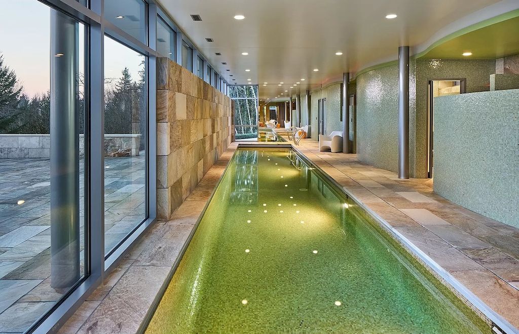 The Architecturally Significant Contemporary House in Oregon offers the perfect balance between function & form now available for sale. This home is located at 9912 NW Wind Ridge Dr, Portland, Oregon