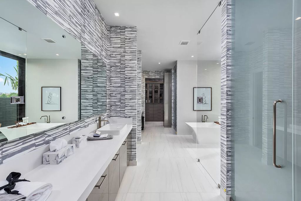 The Home in Boca Raton is a modern one story estate features a fabulous entertaining backyard with upgraded summer kitchen now available for sale. This home located at 17242 Brulee Breeze Way, Boca Raton, Florida