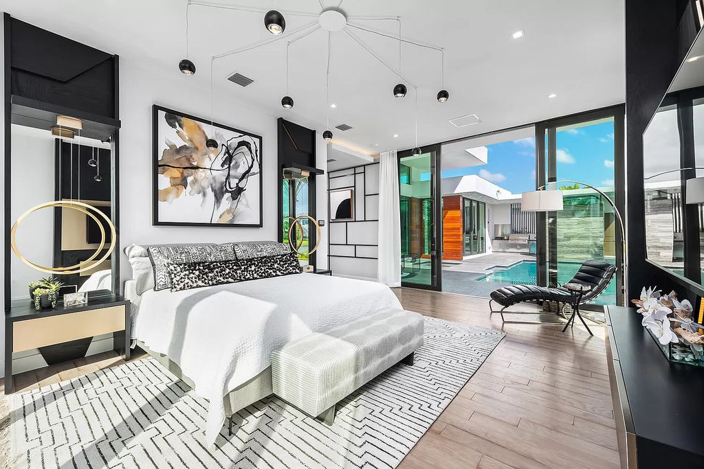 The Home in Boca Raton is a modern one story estate features a fabulous entertaining backyard with upgraded summer kitchen now available for sale. This home located at 17242 Brulee Breeze Way, Boca Raton, Florida