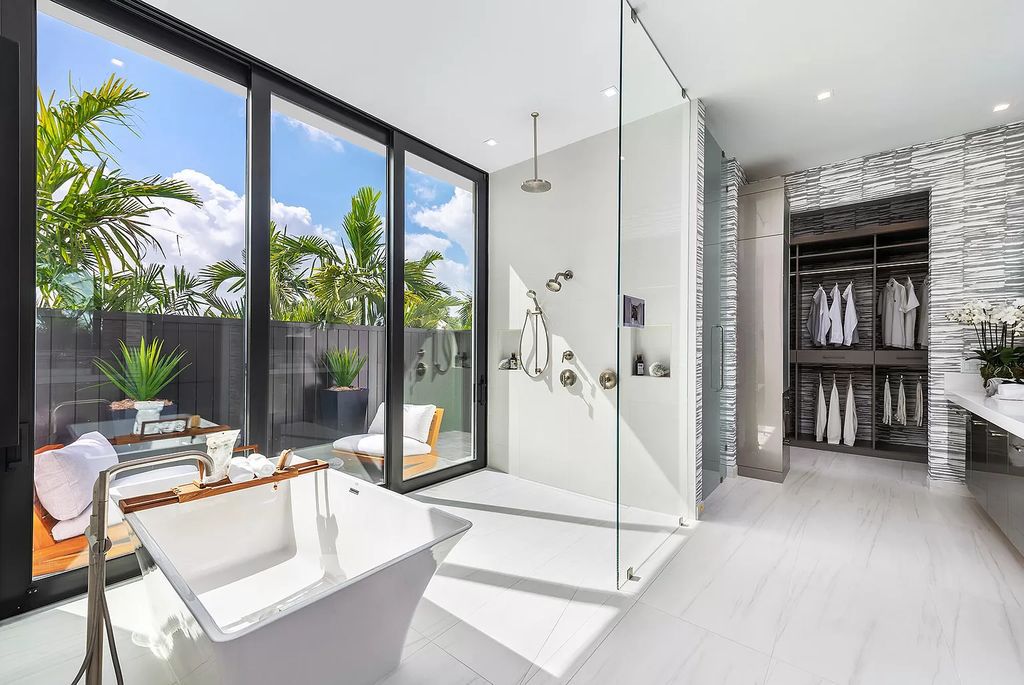The Home in Boca Raton is a modern one story estate features a fabulous entertaining backyard with upgraded summer kitchen now available for sale. This home located at 17242 Brulee Breeze Way, Boca Raton, Florida