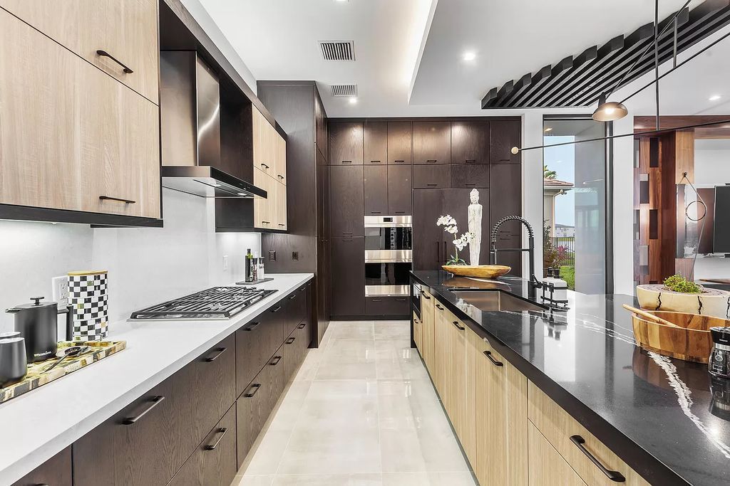 The Home in Boca Raton is a modern one story estate features a fabulous entertaining backyard with upgraded summer kitchen now available for sale. This home located at 17242 Brulee Breeze Way, Boca Raton, Florida