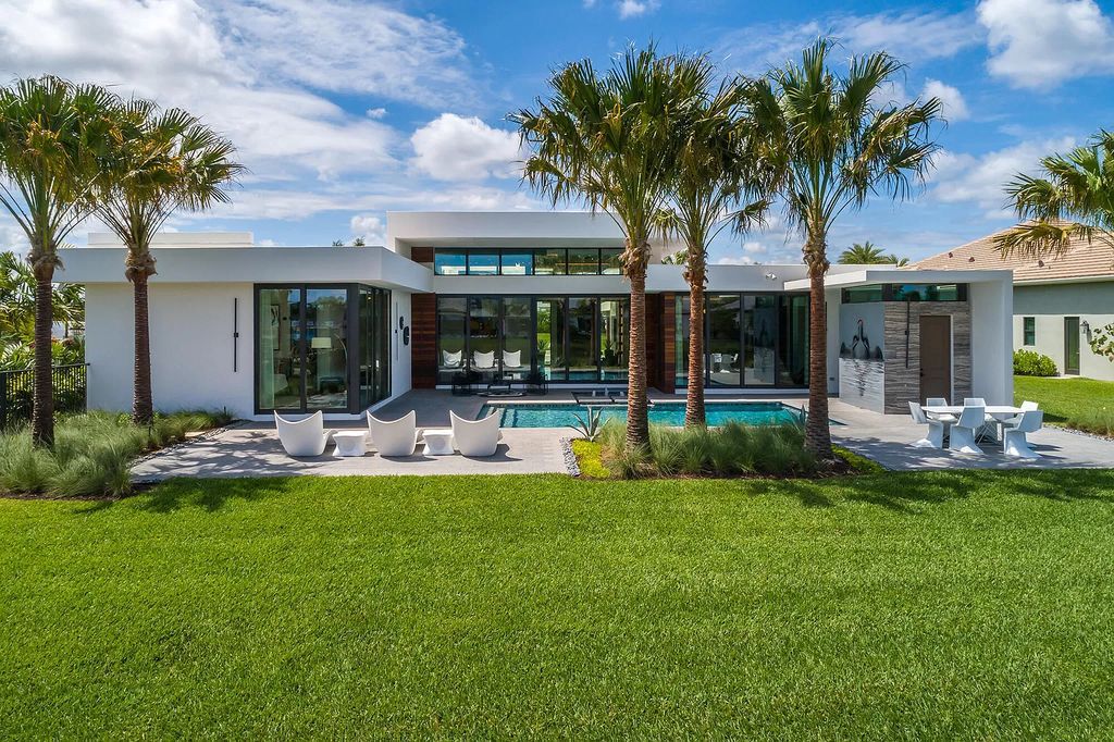 The Home in Boca Raton is a modern one story estate features a fabulous entertaining backyard with upgraded summer kitchen now available for sale. This home located at 17242 Brulee Breeze Way, Boca Raton, Florida