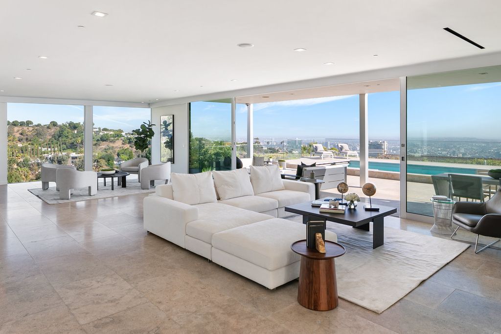 The Home in Beverly Hills is a totally remodeled and updated contemporary estate with head on city to ocean views now available for sale. This home located at 1476 Carla Rdg, Beverly Hills, California