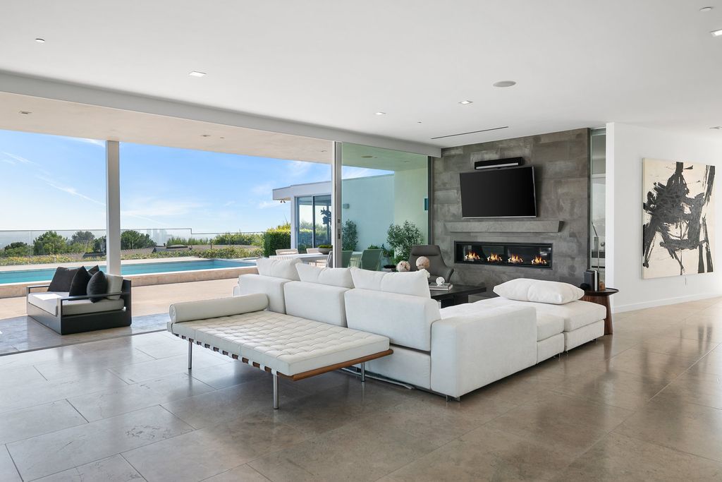 The Home in Beverly Hills is a totally remodeled and updated contemporary estate with head on city to ocean views now available for sale. This home located at 1476 Carla Rdg, Beverly Hills, California