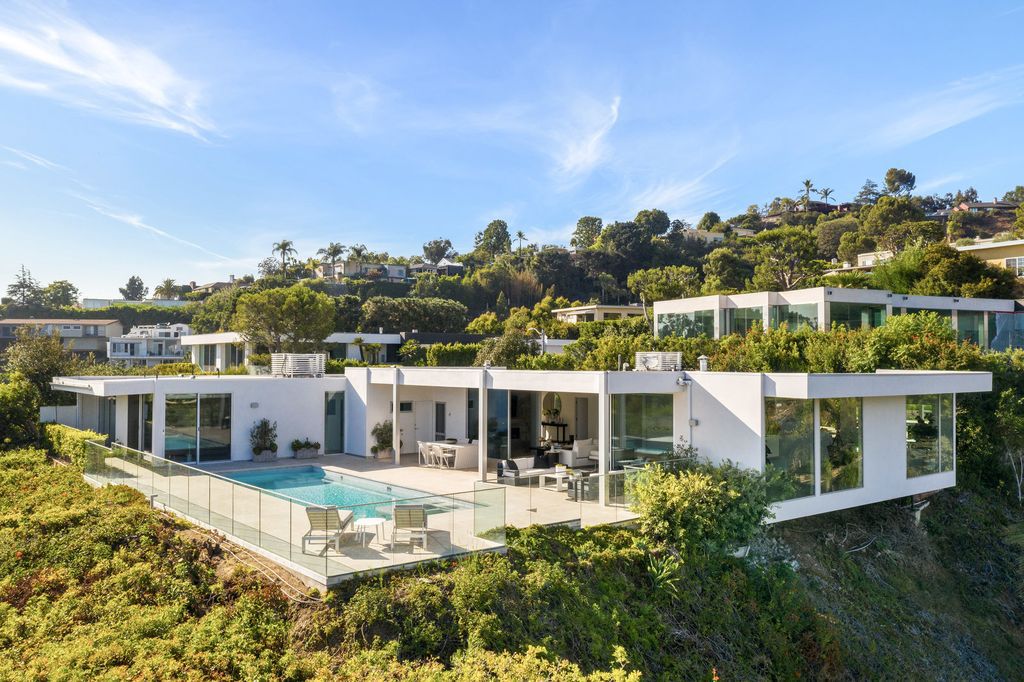 The Home in Beverly Hills is a totally remodeled and updated contemporary estate with head on city to ocean views now available for sale. This home located at 1476 Carla Rdg, Beverly Hills, California