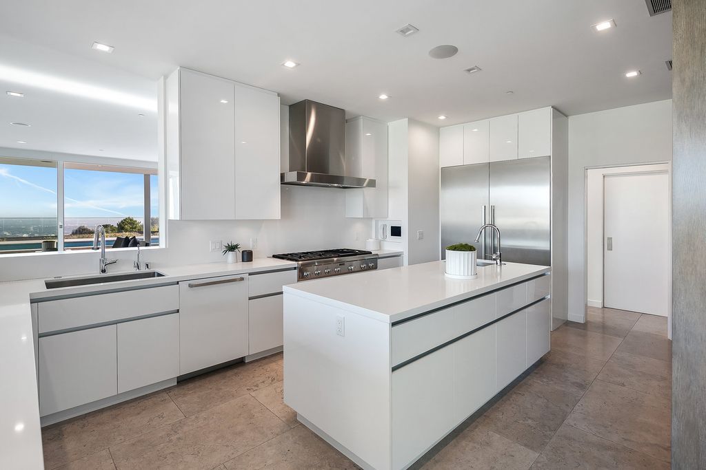 The Home in Beverly Hills is a totally remodeled and updated contemporary estate with head on city to ocean views now available for sale. This home located at 1476 Carla Rdg, Beverly Hills, California