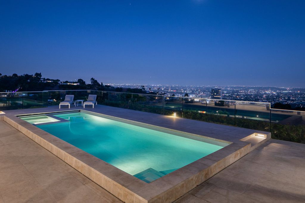 The Home in Beverly Hills is a totally remodeled and updated contemporary estate with head on city to ocean views now available for sale. This home located at 1476 Carla Rdg, Beverly Hills, California