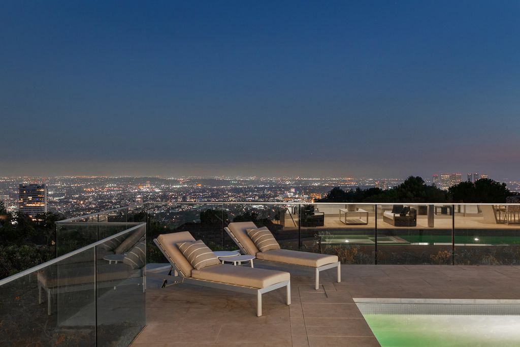 The Home in Beverly Hills is a totally remodeled and updated contemporary estate with head on city to ocean views now available for sale. This home located at 1476 Carla Rdg, Beverly Hills, California