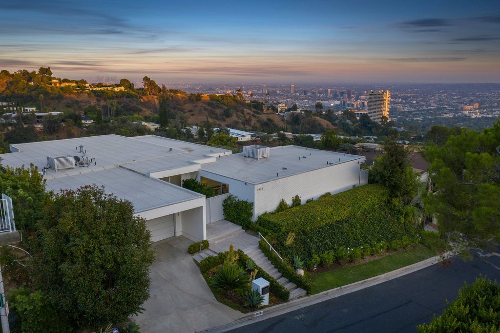 The Home in Beverly Hills is a totally remodeled and updated contemporary estate with head on city to ocean views now available for sale. This home located at 1476 Carla Rdg, Beverly Hills, California